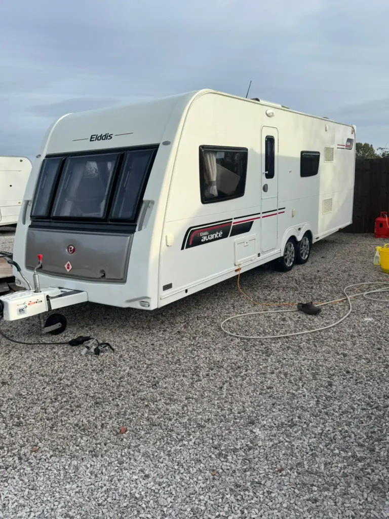 Twin axle touring caravan on a gravel driveway