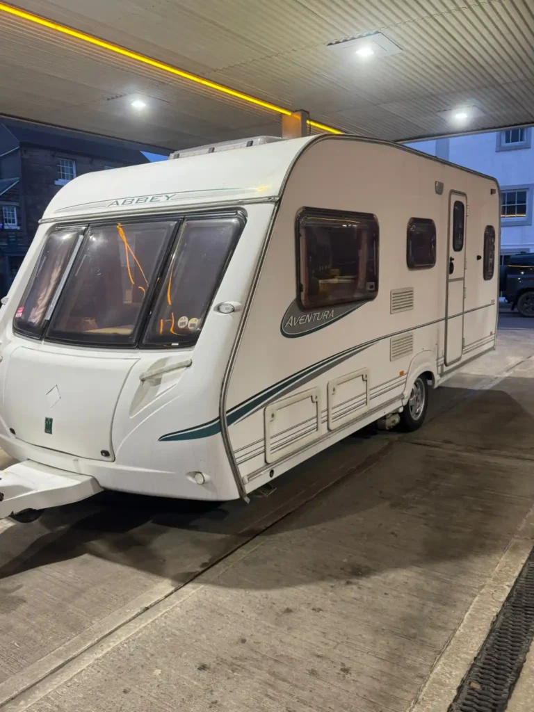 Touring caravan collected at sunset on a residential road