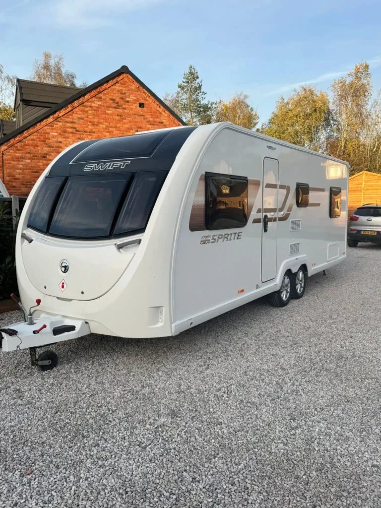 Touring caravan being towed away from a fuel station