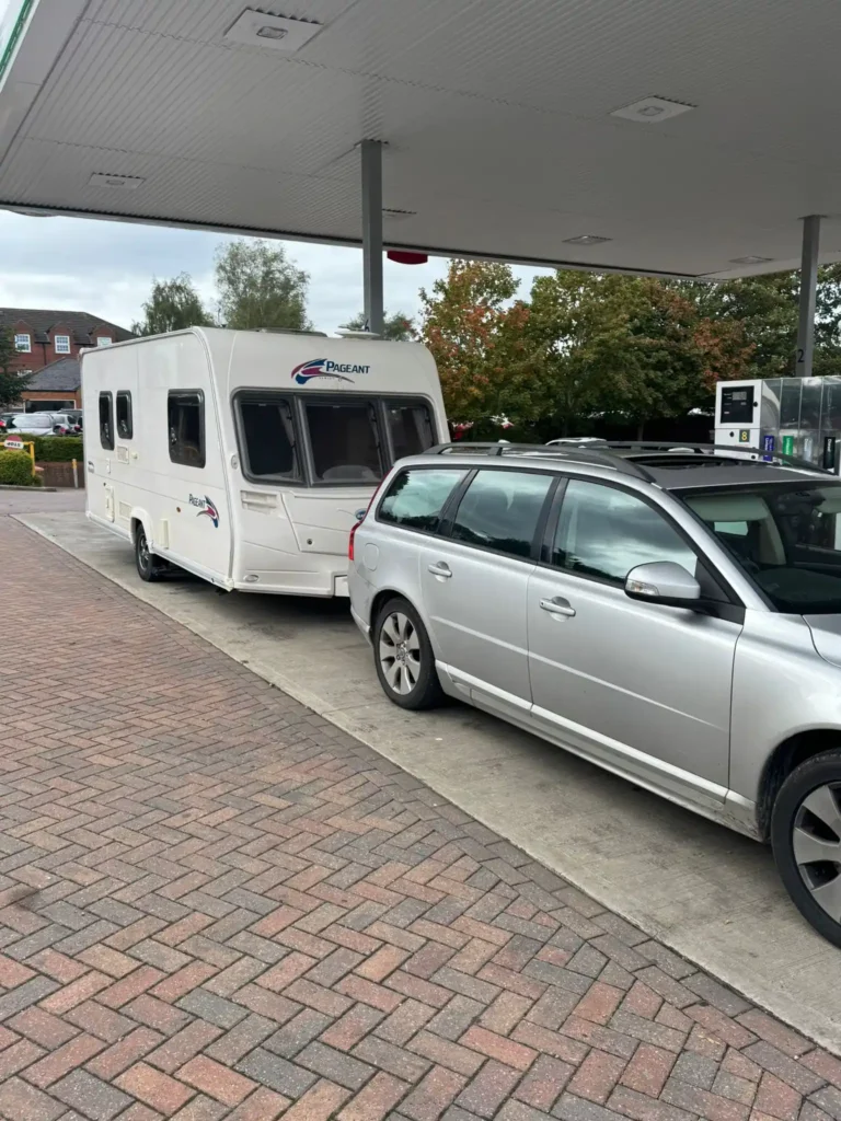 Touring caravan hitched to a 4×4 on a residential street